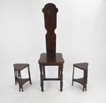 A late 19th century oak hall chair with solid back and seat on turned underframing, and two small
