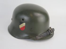 A World War II Wehrmacht model 1935 lightweight helmet, with transfers, leather liner and chin