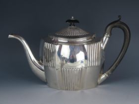 A George III silver teapot, maker Timothy Renou, London, 1802, of oval form, with domed and reeded