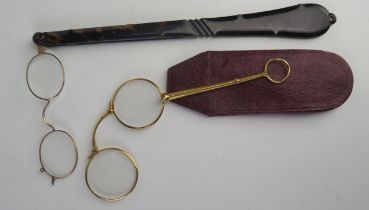 A pair of gilt metal lorgnettes contained in a Morocco leather case, and a pair of lorgnettes with