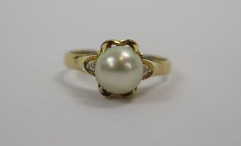 A Modern 18K Pearl or Cultured Pearl and Diamond Ring, 7.6mm pearl, size M.5, stamped 18K, 3.77g