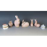 A collection of Herend porcelain models of rabbits, the largest 14cm high, together with two