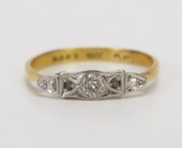 An 18ct Gold and Diamond Three Stone Ring platinum set with an old cut flanked by rose cuts, size