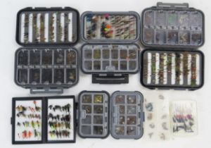 A collection of assorted trout and sea trout flies, including wet and dry flies, lures and nymphs,