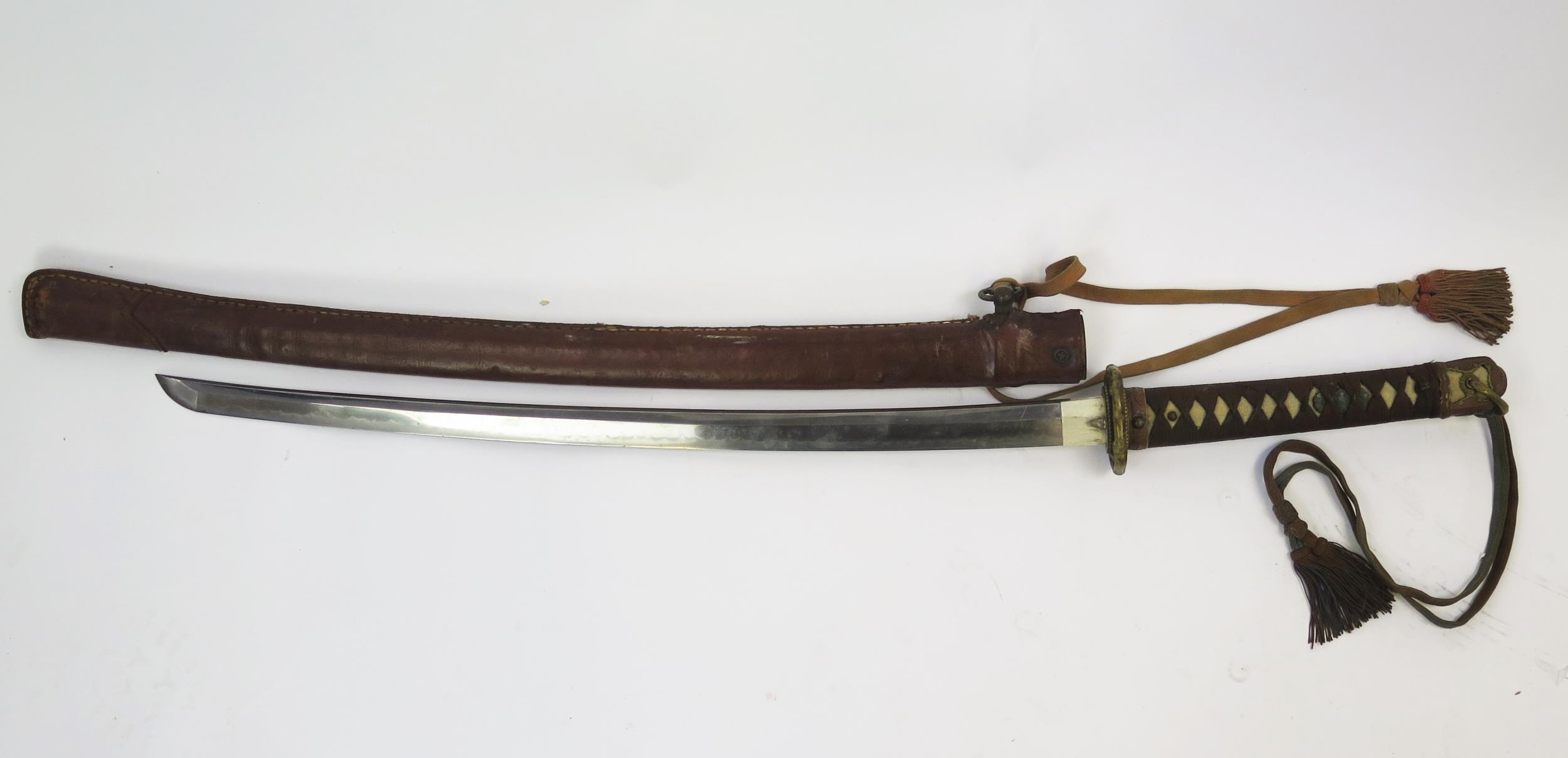 A Japanese World War II officers katana, with 63cm signed blade with bronze tsuba with cherry