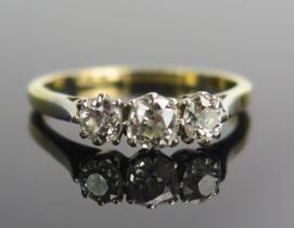 An 18ct Gold and Diamond Three Stone Ring, c. 4mm principal old cut platinum set, size M.5,