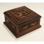 An Anglo-Indian (Mysore) carved sandalwood casket, of square outline, the hinged lid decorated with