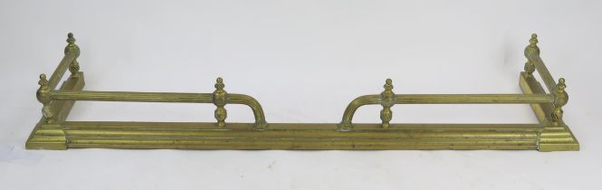 A 19th century brass fire kerb of rectangular outline, with reeded rail mounts, on a stepped base,