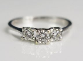 A Modern 18ct White Gold and Diamond Three Stone Ring, 3.6mm principal stone, 3.37mm shoulder