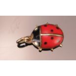An Enamel Ladybird Charm in a precious yellow metal setting, KEE tests as 9ct, .48g. UNLESS