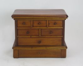 A mahogany vanity box in the form of a chest, with hinged top enclosing a mirror, with an