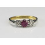 An 18ct Gold, Ruby and Diamond Three Stone Ring, 4mm ruby flanked by platinum illusion set, size L.