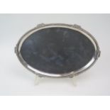 A silver oval tray, stamped 'silver' with moulded foliate and gadrooned rim, 28cm wide, 319gms, 10.