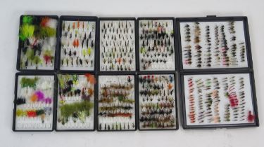 A collection of assorted trout and sea trout flies, including wet and dry flies, lures and nymphs,