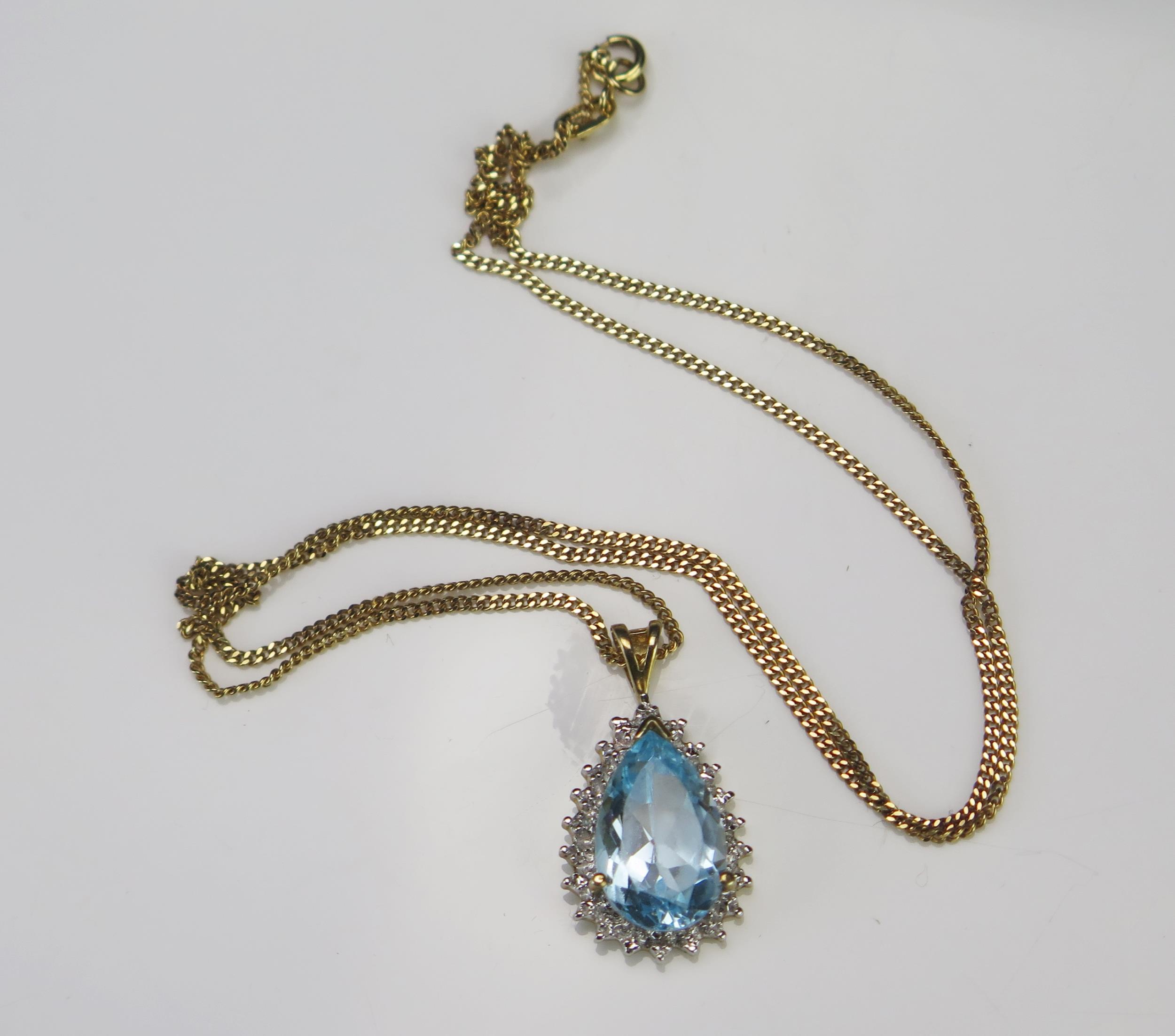 A Blue Topaz Tear Drop Pendant (24.3mm drop) on an 18" (46cm) 9ct gold chain, hallmarked, 2.57g