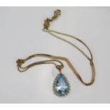 A Blue Topaz Tear Drop Pendant (24.3mm drop) on an 18" (46cm) 9ct gold chain, hallmarked, 2.57g