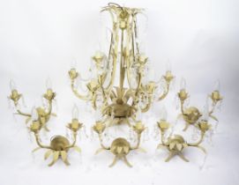 A painted metal nine branch electrolier, with foliate decorated sconces with faceted glass drops,