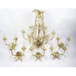 A painted metal nine branch electrolier, with foliate decorated sconces with faceted glass drops,