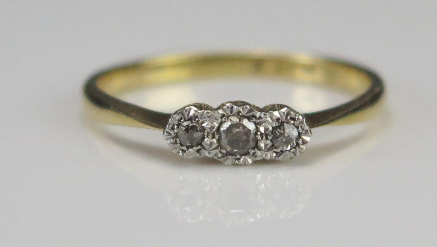 An 18ct Gold and Diamond Three Stone Platinum Illusion Set Ring, stamped CT PLAT, size O.75, 2.16g