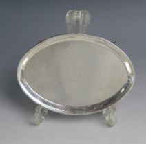 A George III silver teapot stand, maker William Plummer, London, 1784, crested, of oval outline,