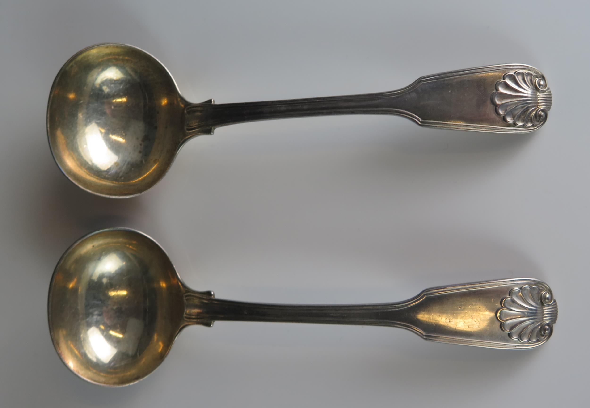 A pair of Victorian silver Fiddle, Thread and Shell pattern sauce ladles, maker Robert Williams &