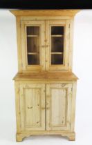 A Victorian style stripped pine dresser, the upper part with a moulded cornice and a pair of