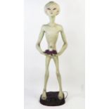 Life Size Alien Resin Figure holding a lamp (wired and working) standing on a purple rock base, 49.