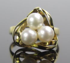 A 14K Cultured Pearl Ring in a triangular entwined setting, 14.8mm head, size O, stamped `4K 585,