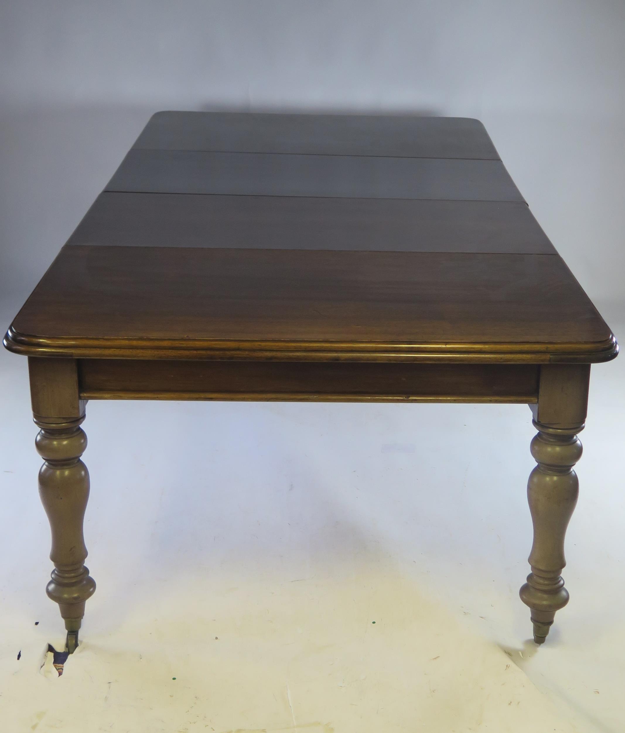 A Victorian mahogany extending dining table, the rectangular top with a moulded edge raised on - Image 2 of 2