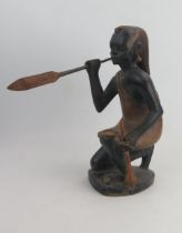 An African Carved Wooden Model of a hunter with spear, signed John Ngony, 32cm tall