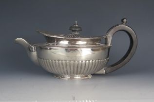 A George III silver teapot, maker Richard Cook, London, 1808, crested, of circular form, with beaded