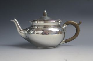 An Edward VII silver bachelors teapot, maker Charles Edwards, London, 1906, of squat circular