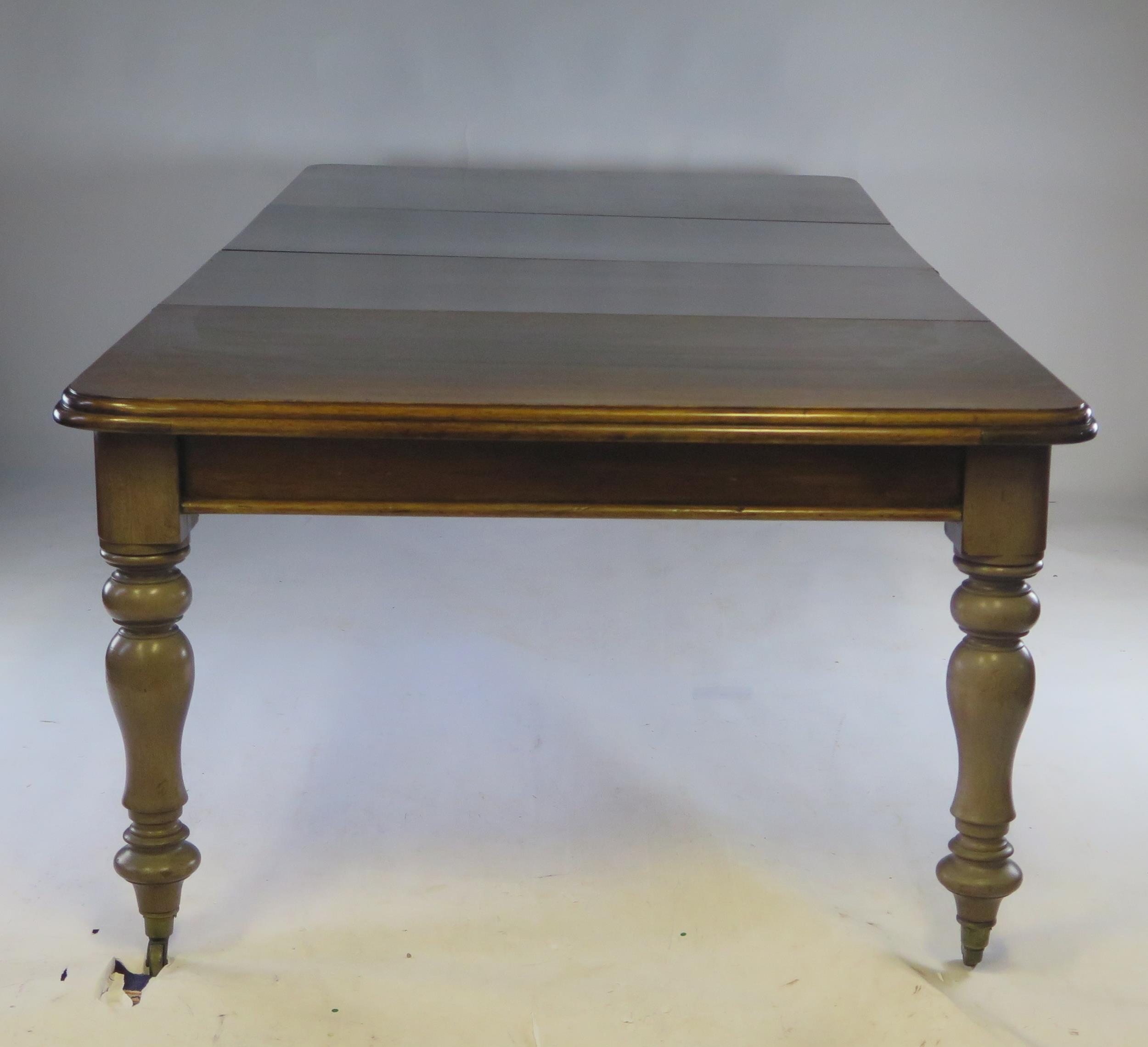 A Victorian mahogany extending dining table, the rectangular top with a moulded edge raised on