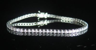 An 18ct White Gold and Diamond Tennis Bracelet in an Ernest Jones box, set with c. 1.9mm stones, 7.