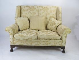 A Mahogany Framed Upholstered Sofa with ball and claw feet, 140cm wide