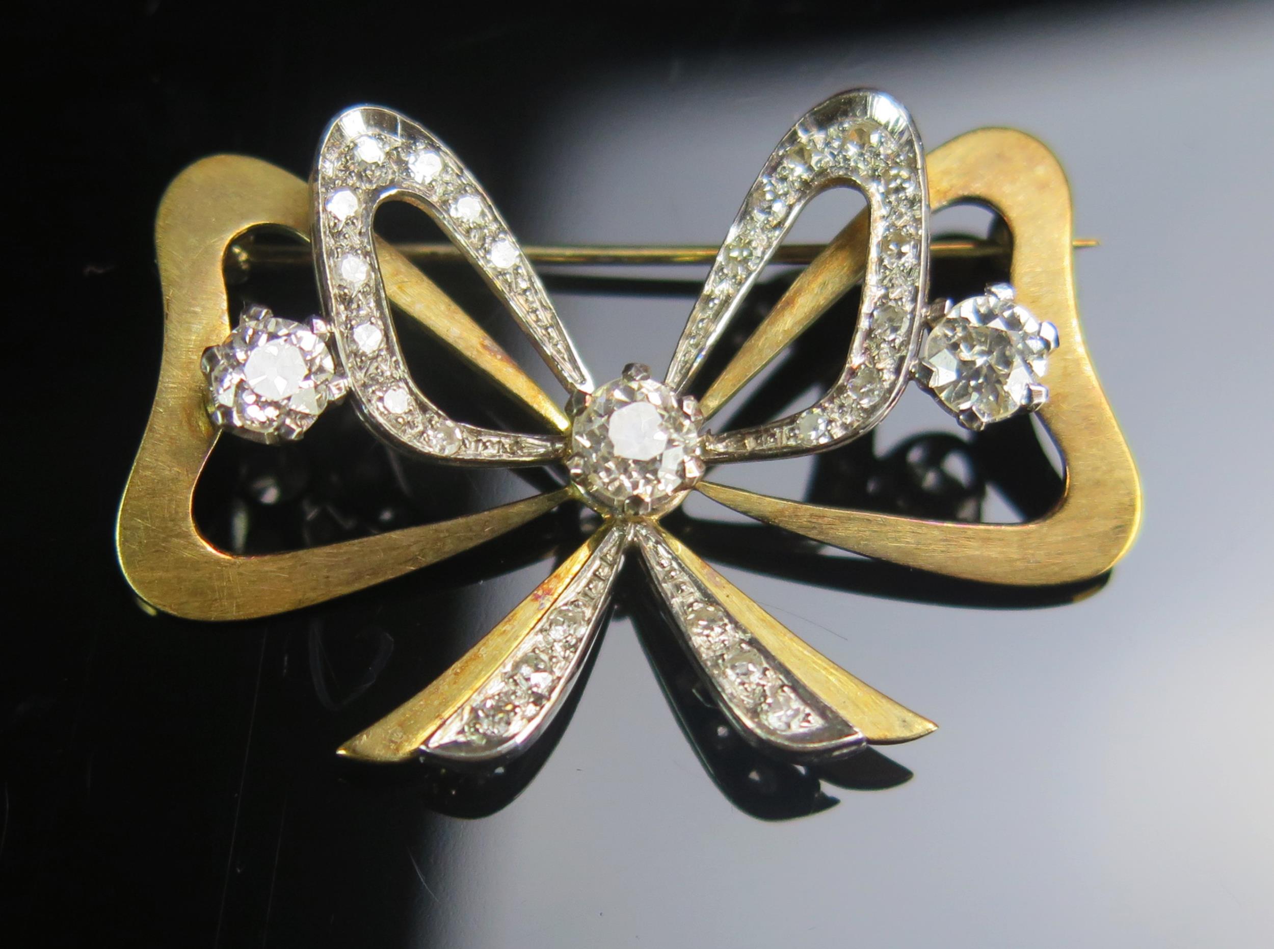 An Old Cut Diamond Bow Brooch in a precious yellow and white metal setting, c, 5mm principal