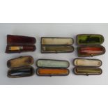 A collection of six assorted amber and other cheroot holders, all cased.