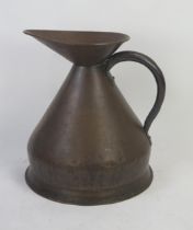 A large copper measure of traditional design, with loop handle 50cm high.
