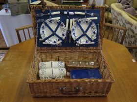 A wicker picnic hamper, containing Churchill pottery mugs, plates, cutlery and glasswares, bottle