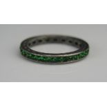 A Precious White Metal and Green Paste Eternity Ring, size L, 1.52g