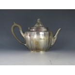An Edward VII silver teapot, maker Walker & Hall, Chester, 1906, of oval form, the domed hinged