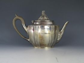 An Edward VII silver teapot, maker Walker & Hall, Chester, 1906, of oval form, the domed hinged
