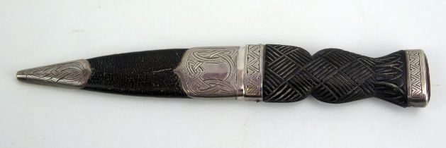 A George V skhin dhu with 7cm single edged fullered blade, with woven effect grip and cabochon set