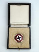 A Third Reich period N.S.D.A.P. party badge, contained in its original case of issue.