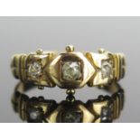 A Victorian 18ct Gold and Diamond Three Stone Ring, set with old mine cut stones with the largest c.