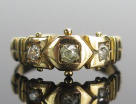 A Victorian 18ct Gold and Diamond Three Stone Ring, set with old mine cut stones with the largest c.