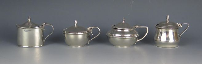 Four assorted silver mustard pots and covers, various makers and dates, three with blue glass