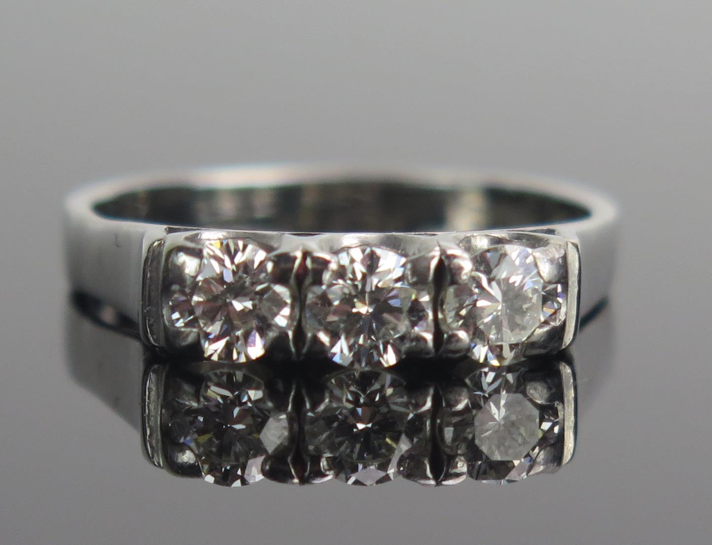 An 18ct White Gold and Diamond Three Stone Ring, set with three c. 4.1mm brilliant round cut stones,