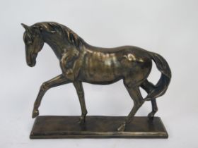 A bronzed resin model of a stallion, on a rectangular plinth base, 41cm long, 34cm high.