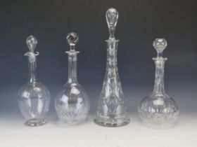 Four assorted clear glass decanter and stoppers, various sizes. (4).